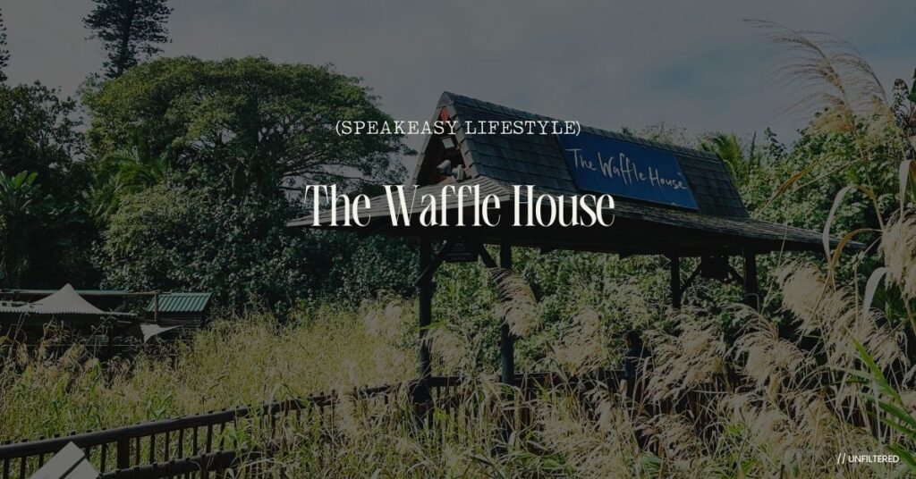 The Waffle House entrance and wooden bridge set among lush coastal trees and reeds in Ramsgate, South Africa.