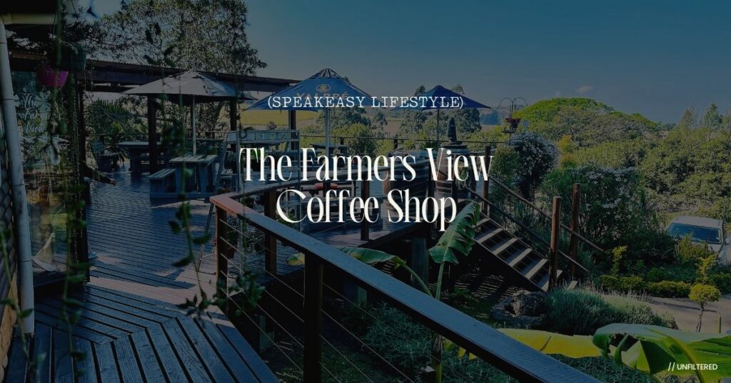 Expansive wooden patio deck with umbrella-shaded outdoor seating and green vistas at The Farmers View Coffee Shop in Oribi Gorge.